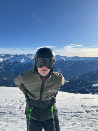 Person in ski gear with a mountainous landscape in the background