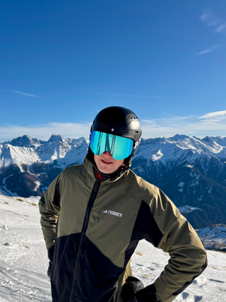 Person in ski gear with mountainous landscape in the background